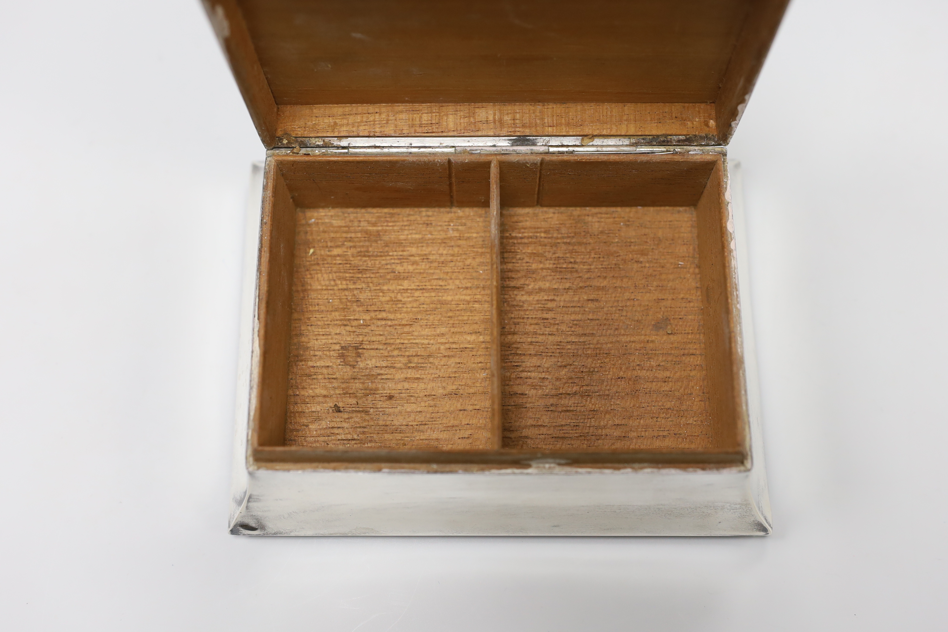 A George V Art Deco part engine turned silver mounted rectangular cigarette case, London, 1932, 15.2cm.